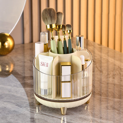 Rotating organizer for makeup brushes and cosmetics in champagne color on vanity table.