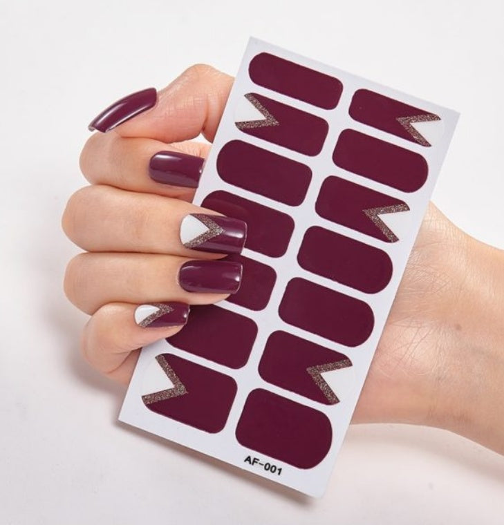 THE PRINTED NAILS adhesive nail stickers in deep burgundy color with silver chevron design.